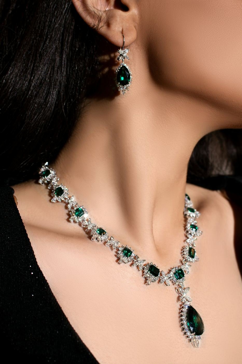 Woman wearing an emerald and diamond necklace