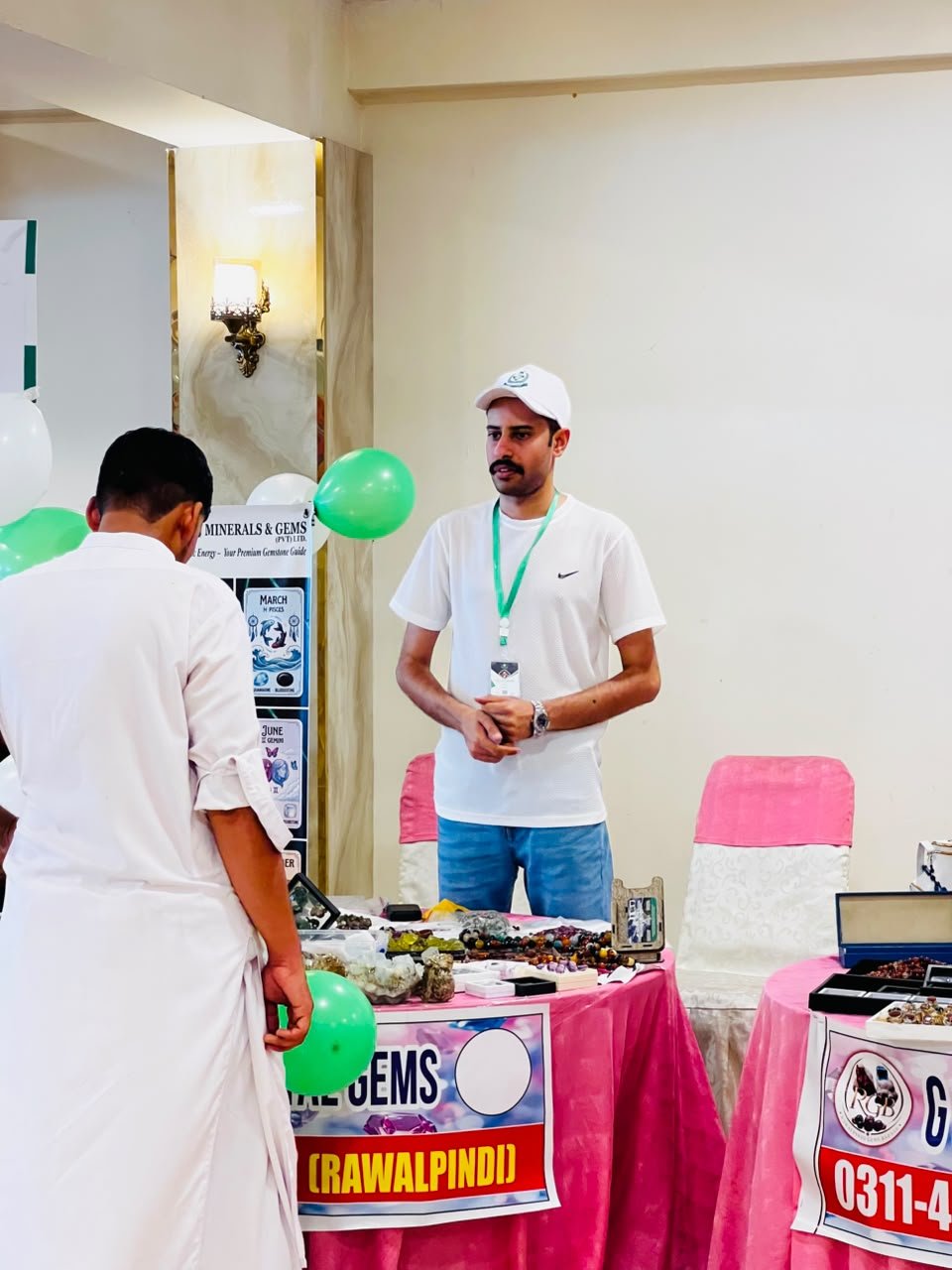 Visitor looking at gemstones on the Pakistan Minerals & Gems table in Rawalpindi