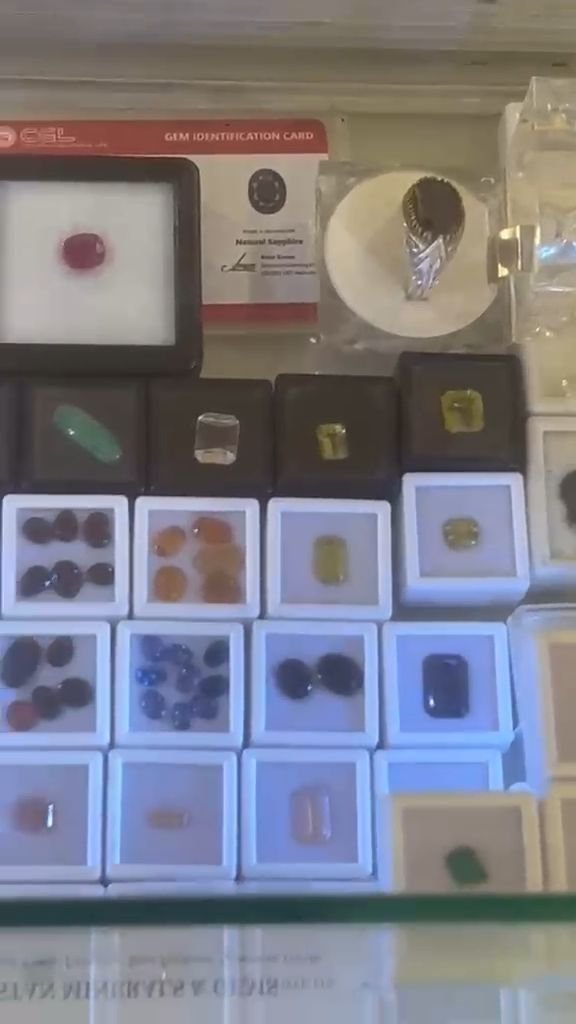 Tour of the Pakistan Minerals & Gems booth showing boxes of loose gemstones